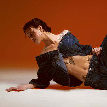 Fashion editorial presenting a coordinated outfit worn by a reclining model, emphasizing styling and fit for inspiration and trend promotion.