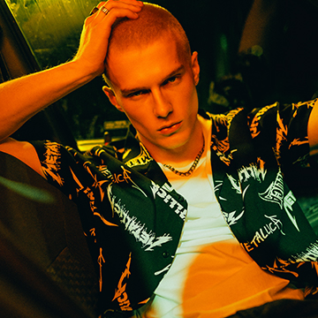 Promotes a casual, edgy streetwear look to inspire outfit styling and express a bold fashion attitude for a contemporary clothing collection.